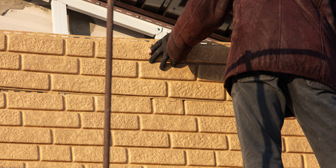 Installation of siding on the walls of the house