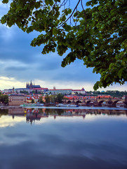 Fototapeta na wymiar A view of Prague Castle and the Charles Bridge across the Vltava River in Prague, Czech Republic.