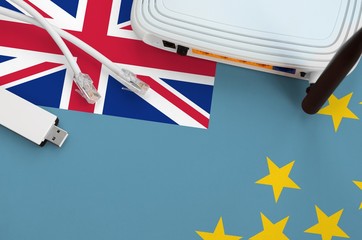 Tuvalu flag depicted on table with internet rj45 cable, wireless usb wifi adapter and router....
