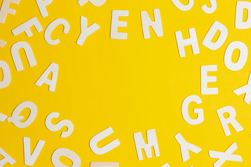 wooden alphabet with space on yellow background