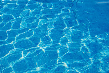 Fototapeta na wymiar Ripple water in the swimming pool with sun reflection