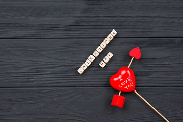 Valentines day. Heart pierced by arrow on wooden table background