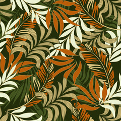 Fototapeta na wymiar Fashionable seamless tropical pattern with bright orange and white plants and leaves on green background. Seamless pattern with colorful leaves and plants. Tropic leaves in bright colors.