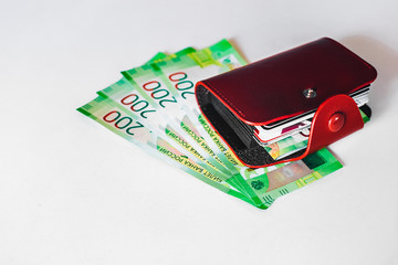 brown leather wallet with plastic cards and Bank of Russia banknotes. Russian money for 200 rubles