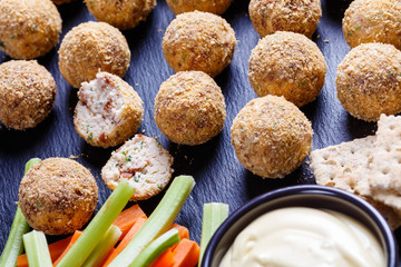 close-up of cheese balls on a black tray