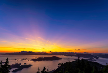Sunset over Ocean, Islands, Silhouetted Mountains 