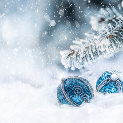 Blue christmas ball on snow with fir branches. Merry Xmas concept