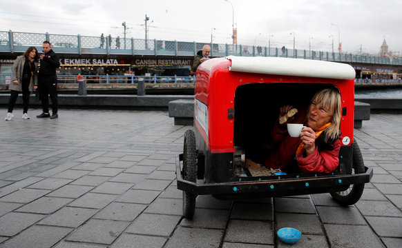 Rosie Swale Pope gives a coffee break in her cart as she runs through Istanbul as part of her solo running from London to Katmandu in Istanbul