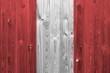 Peru flag depicted in bright paint colors on old wooden wall. Textured banner on rough background