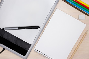 Mock-up. Concept. Tablet for drawing and a white sheet of paper. technology comparison.