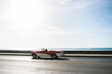old car driving on highway in Havana, Cuba