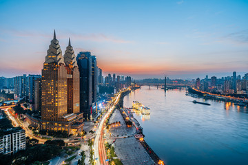Obraz premium Night view of golden high-rise buildings along the Yangtze River in Chongqing, China