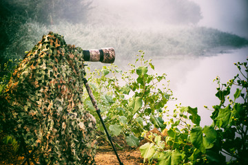 a camouflaged bird photographer