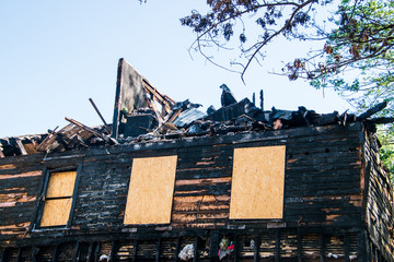 arded up top floor of a two story house that was destroyed by fife. The front is charred and siding...