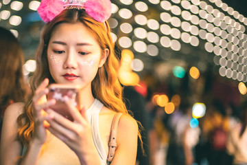 Traveler Asian blogger women travel in Bangkok, Thailand, beautiful female using .Beautiful smiling tourist young  woman having fun at amusement park at hot summer day trip.