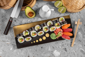 Obraz na płótnie Canvas Sushi set with maki roll, fresh salmon and tuna nigiri