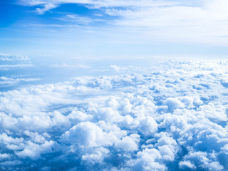 Fototapeta premium Clouds from airplane window with blue sky