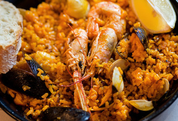 Shrimps in paella, traditional Mediterranean food in a restaurant plate. Seafood