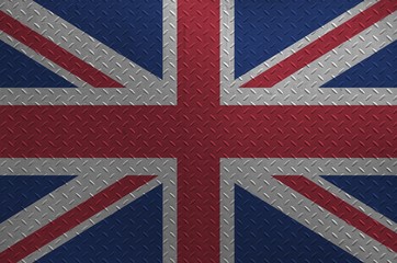 Great britain flag depicted in paint colors on old brushed metal plate or wall closeup. Textured...