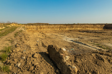 dig up dirt ground field for building foundation landscaping infrastructure object 