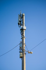 antenna with telecommunication equipment on blue sky background