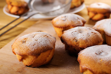 Homemade yeast buns on white plate on black table
