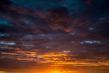 Naklejka na ściany i meble Contract dramatic sky with dark clouds during sunrise