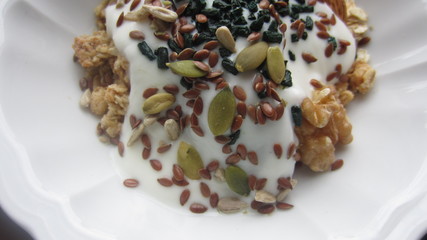 muesli with pumpkin seeds and flax seed and walnuts and yoghurt in a bowl for breakfast