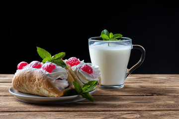 kefir is decorated with a leaf of mint, a fermented drink. Air cake on a saucer.