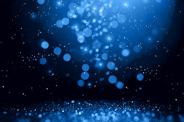 Blue abstract bokeh on black background. Holiday concept