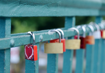 Padlocks on a metal bridge heart design