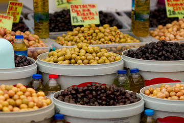 Different olives and olive oil on display at farmer's market