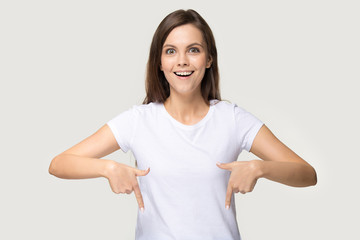 Excited millennial woman headshot showing down with her fingers