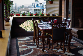 Luxury decorated table for a romantic meetings, cutlery, glasses for wine.