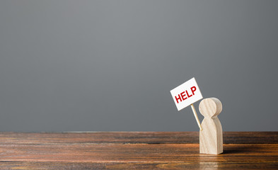 A human figurine asking for help. Support and assistance, providing funding and information to...