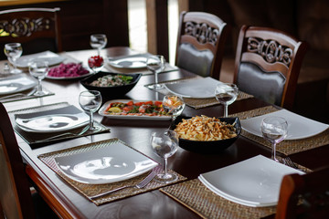 Luxury decorated table for a romantic meetings, cutlery, glasses for wine.