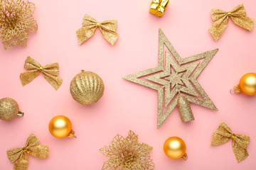 Christmas composition with gold decoration on pink background