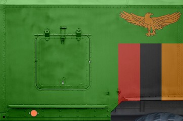 Zambia flag depicted on side part of military armored truck closeup. Army forces conceptual background