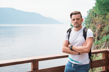 Man portrait on Teletskoye lake in Altai mountains, Siberia, Russia. Beauty summer day.