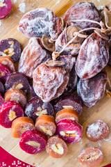 Dried persimmons and churchkhela - Georgian traditional winter holidays sweet dessert.