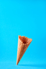Waffle cone over a blue background