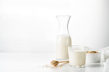 Oat milk in glass  on the  white background.