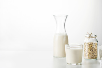 Oat milk in glass  on the  white background.