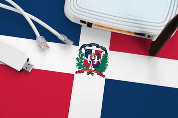 Dominican Republic flag depicted on table with internet rj45 cable, wireless usb wifi adapter and...