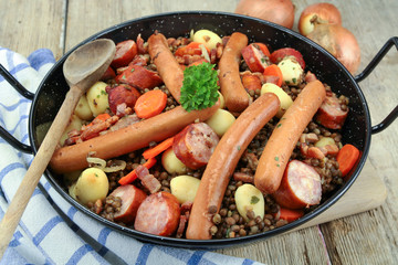 sausage and lentils dish on a wooden table