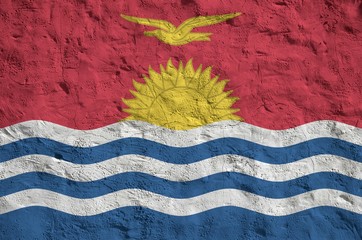 Kiribati flag depicted in bright paint colors on old relief plastering wall. Textured banner on...