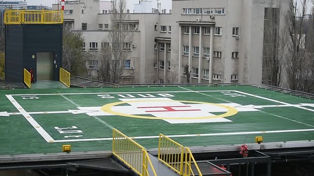 Helipad platform outside an emergency hospital with urban landscape in the background 