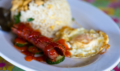 Sausage, egg and rice on a plate. Malaysian local cuisine