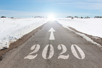 happy new year concept of snowy road heading to 2020