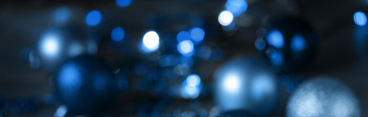 Christmas blue background with bokeh, lights and Christmas balls. defocus. blurred focus. copy space